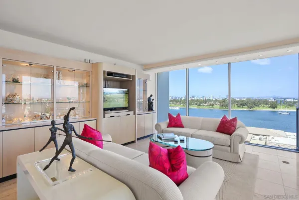 a living room with furniture and a floor to ceiling window
