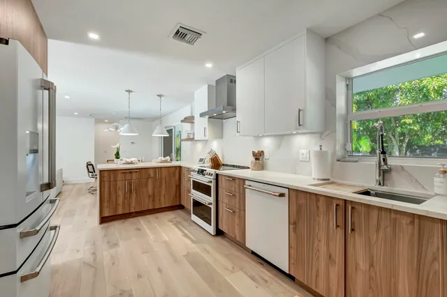 a kitchen with a sink window and cabinets