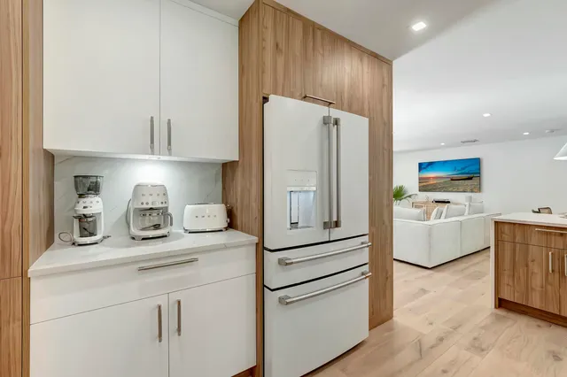 a kitchen with stainless steel appliances a refrigerator sink and cabinets