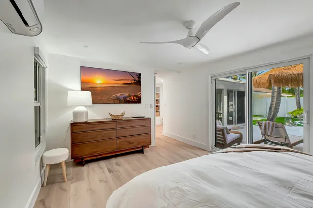 a bedroom with furniture and a flat screen tv