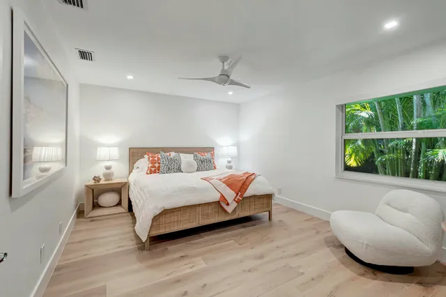 a bedroom with a bed and a couch with window