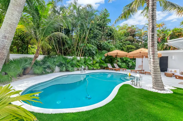 a view of a swimming pool with a yard