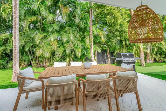 a patio with a yard table and chairs