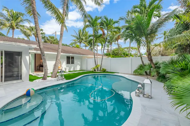 a view of a house with swimming pool and sitting area