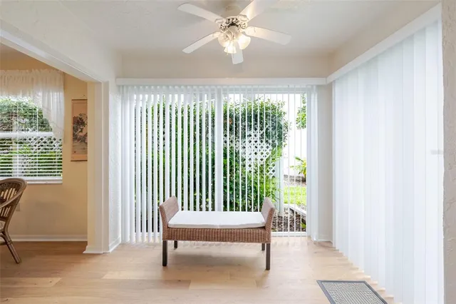 a dining room with furniture a chandelier and wooden floor