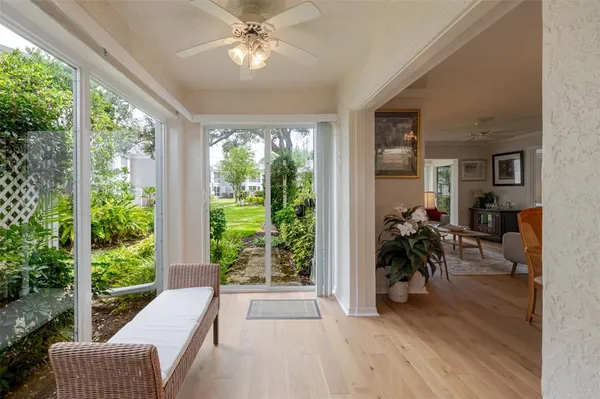 a view of a livingroom with furniture garden view and a large window