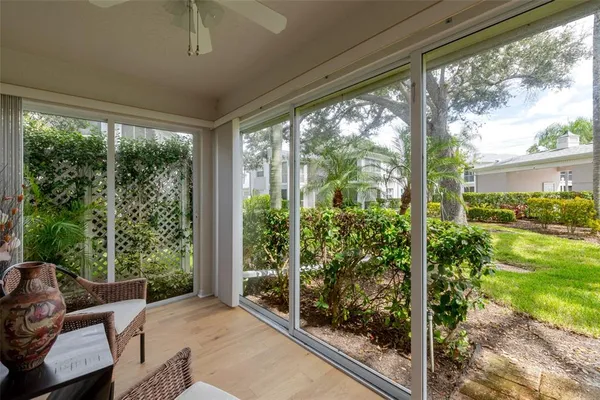 a view of a porch with chairs and backyard