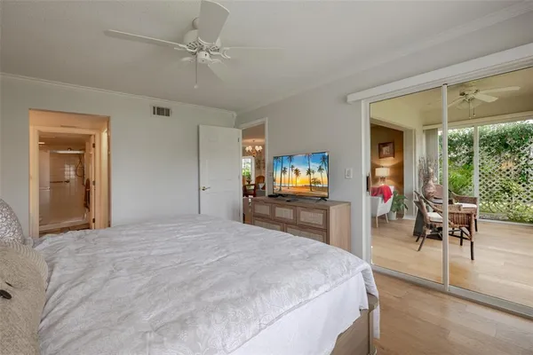 a bedroom with furniture and a flat screen tv