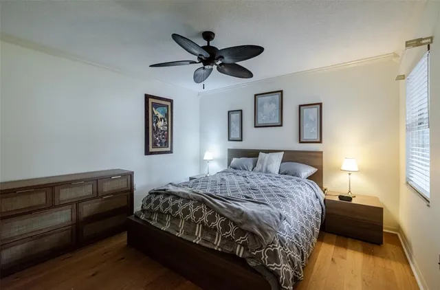 a bedroom with a bed and a painting on the wall
