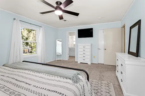 a bedroom with a large bed and a flat tv screen