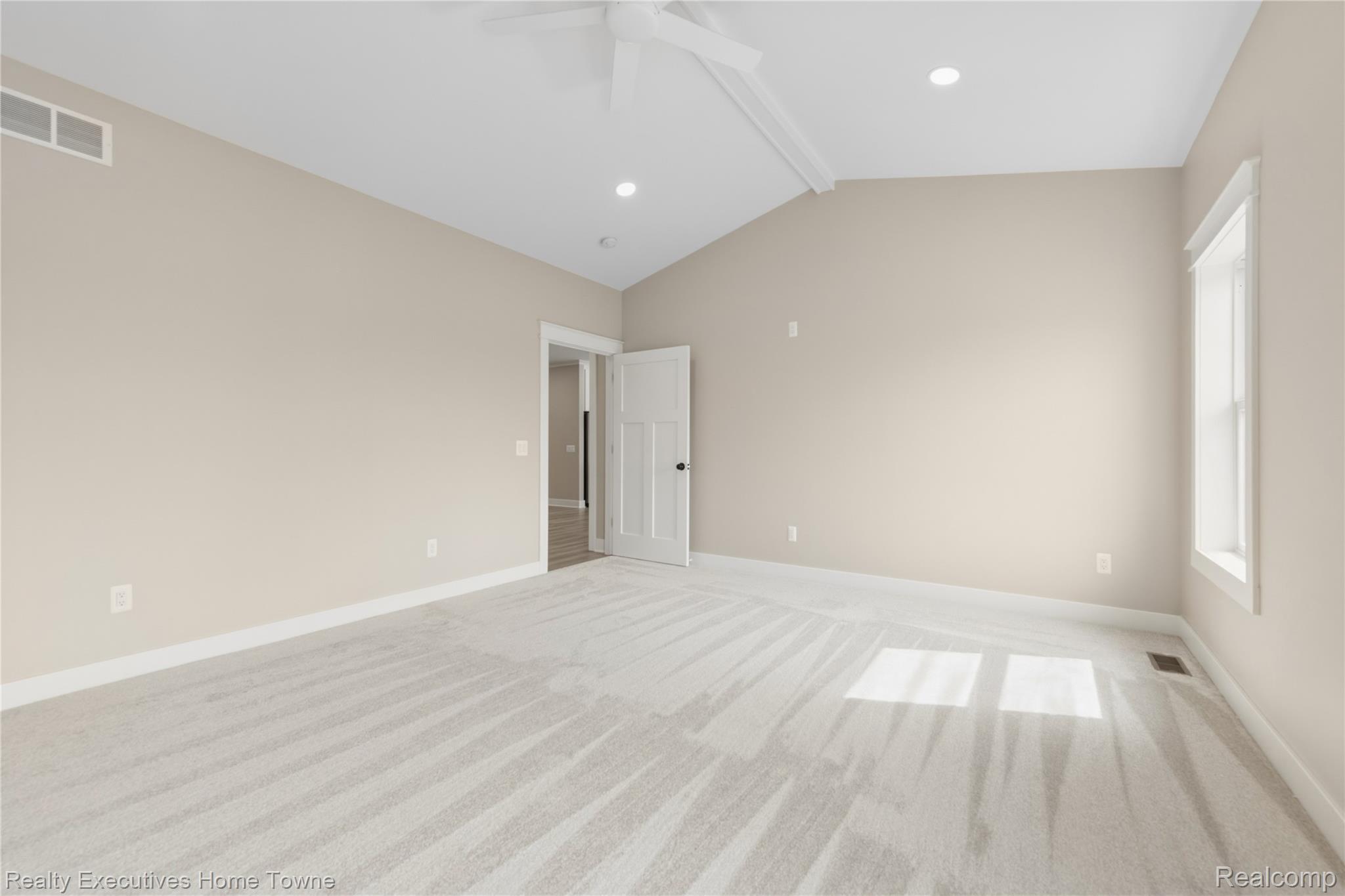 26850 Irwin Road Richmond, MI 48062 - Photo 11 of 47 Spare room featuring beam ceiling, light carpet, and ceiling fan