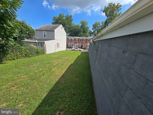 a backyard of a house with barbeque oven and outdoor seating