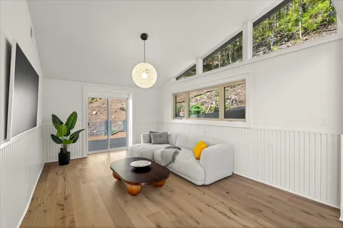 a kitchen with stainless steel appliances a stove and a wooden floor