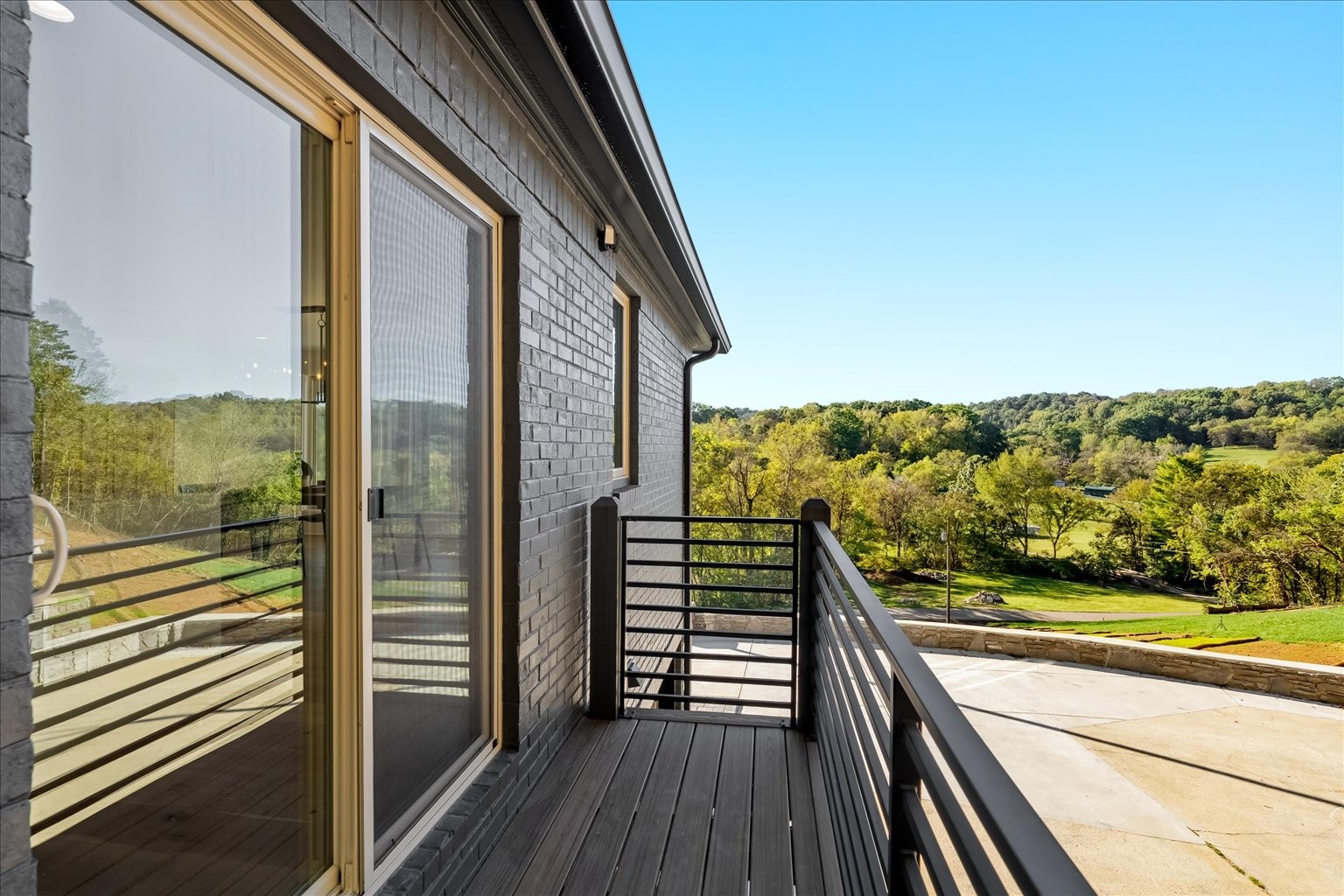 7407 Indian Creek Road Nashville, TN 37209 - Photo 26 of 48 a view of a balcony with floor to ceiling windows with wooden floor
