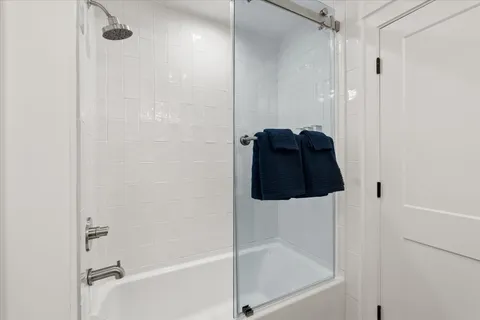 a bathroom with a glass shower door