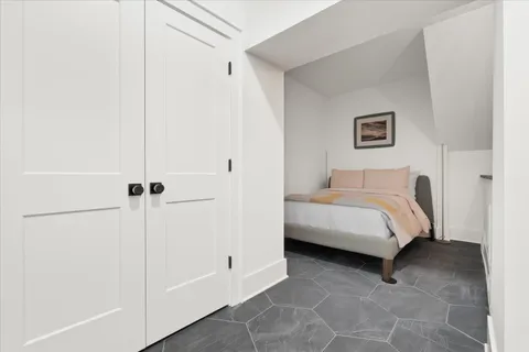a bedroom with a bed and a table