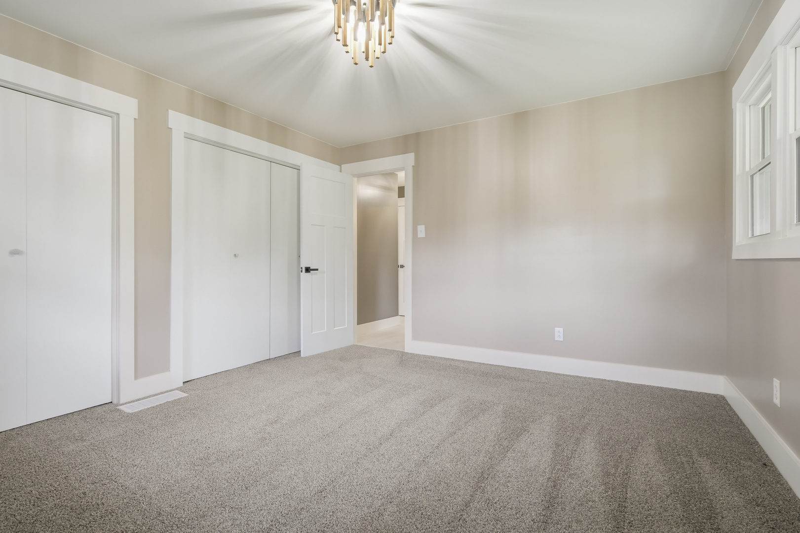7277 East 3000 N Road Cornell, IL 61319 - Photo 13 of 40 an empty room with chandelier fan and windows