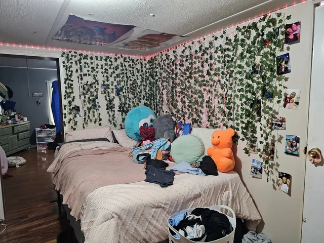 a bed room with a bed and a window