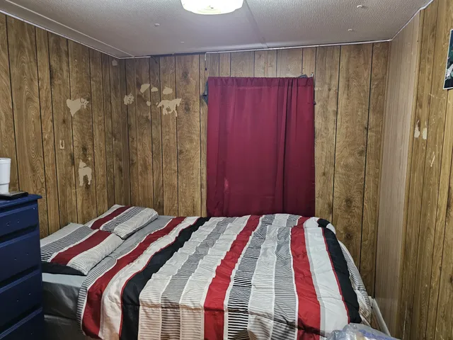 a bedroom with a bed and a mirror