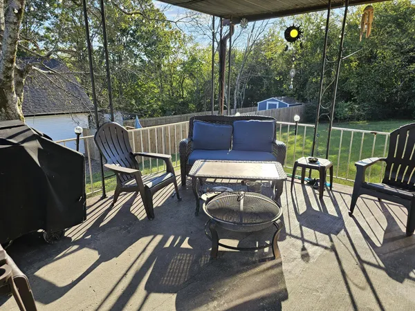 a view of a chairs and table in the patio