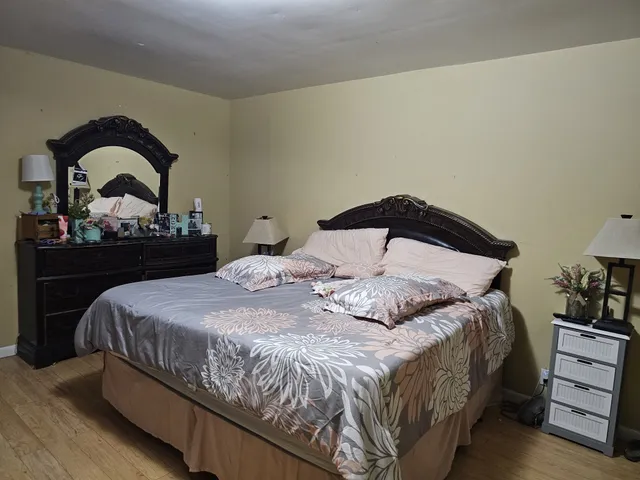 a bedroom with a bed and a dresser