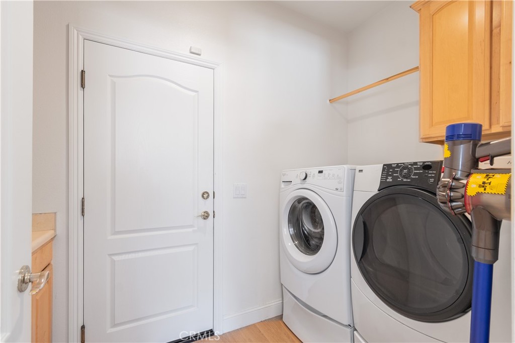 781 Angus Street Paso Robles, CA 93446 - Photo 14 of 34 Inside laundry room with cabinets and door to garage