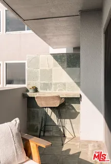 a balcony with table and chairs