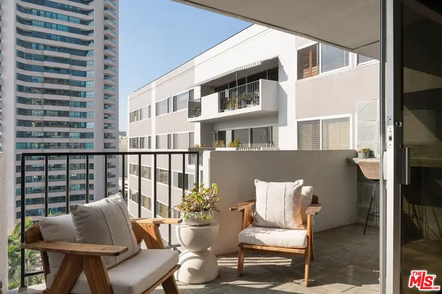 a balcony with table and chairs