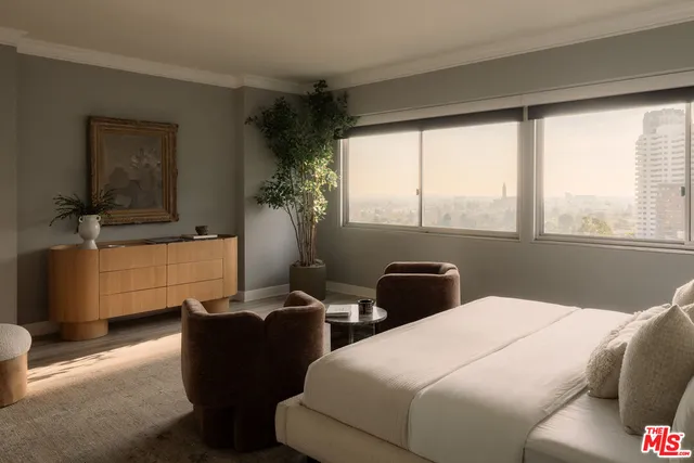 a bedroom with a large bed and a window