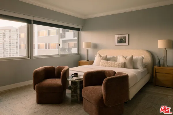 a bedroom with bed couch and window