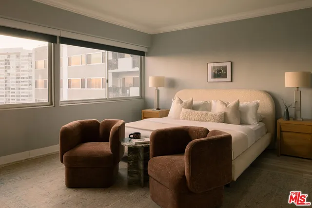 a bedroom with bed couch and window