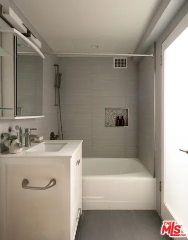 a bathroom with a bathtub and a sink