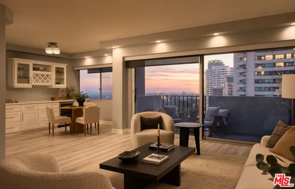 a living room with furniture and a floor to ceiling window