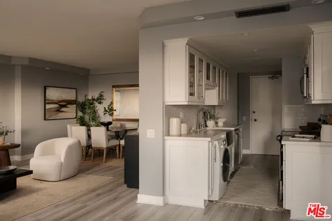 a kitchen with a sink a stove and cabinets