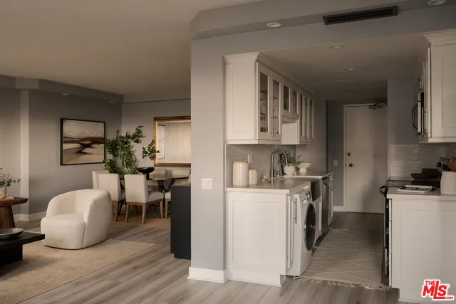 a kitchen with a sink a stove and cabinets