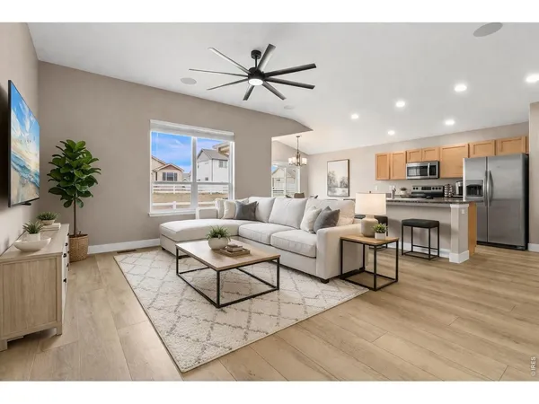 a kitchen with stainless steel appliances granite countertop a refrigerator a stove and a sink