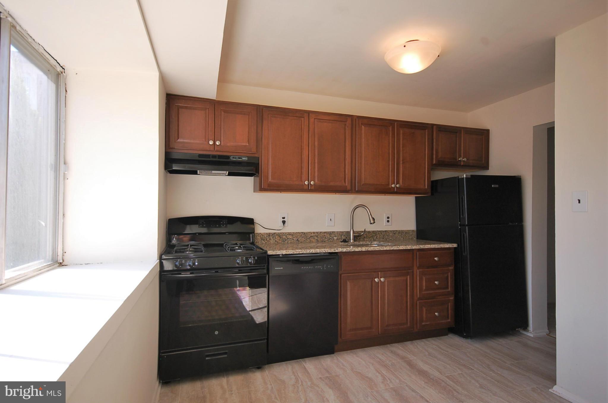 2366 Sun Valley Circle, Unit 2H Silver Spring, MD 20906 - Photo 3 of 16 Updated kitchen with new tile floors and granite.