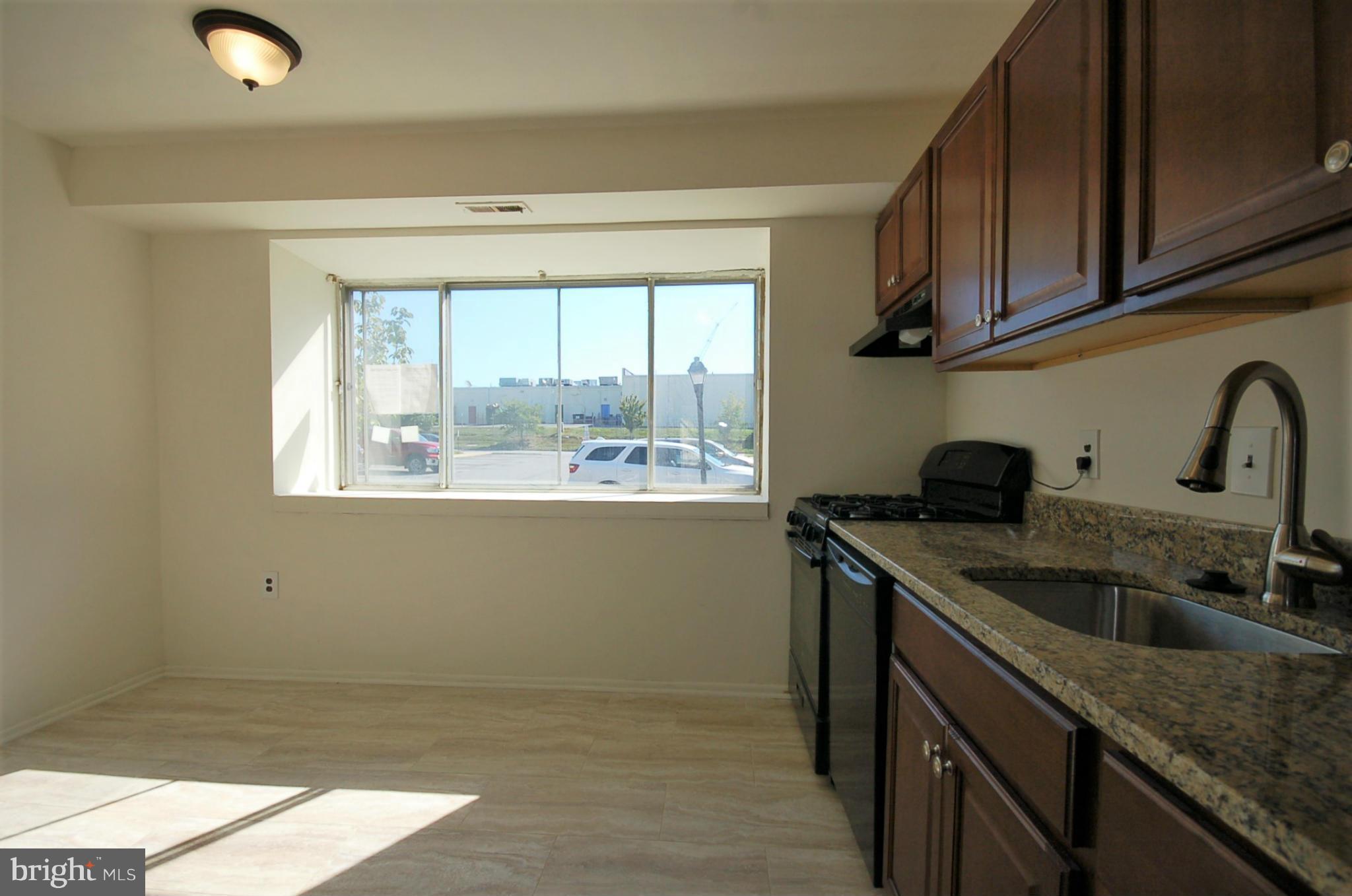 2366 Sun Valley Circle, Unit 2H Silver Spring, MD 20906 - Photo 4 of 16 Spacious eat-in kitchen with new tile and lighting