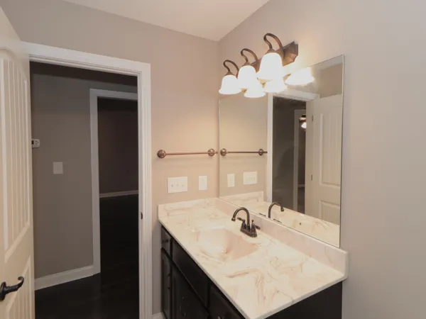 a bathroom with a sink vanity and a mirror