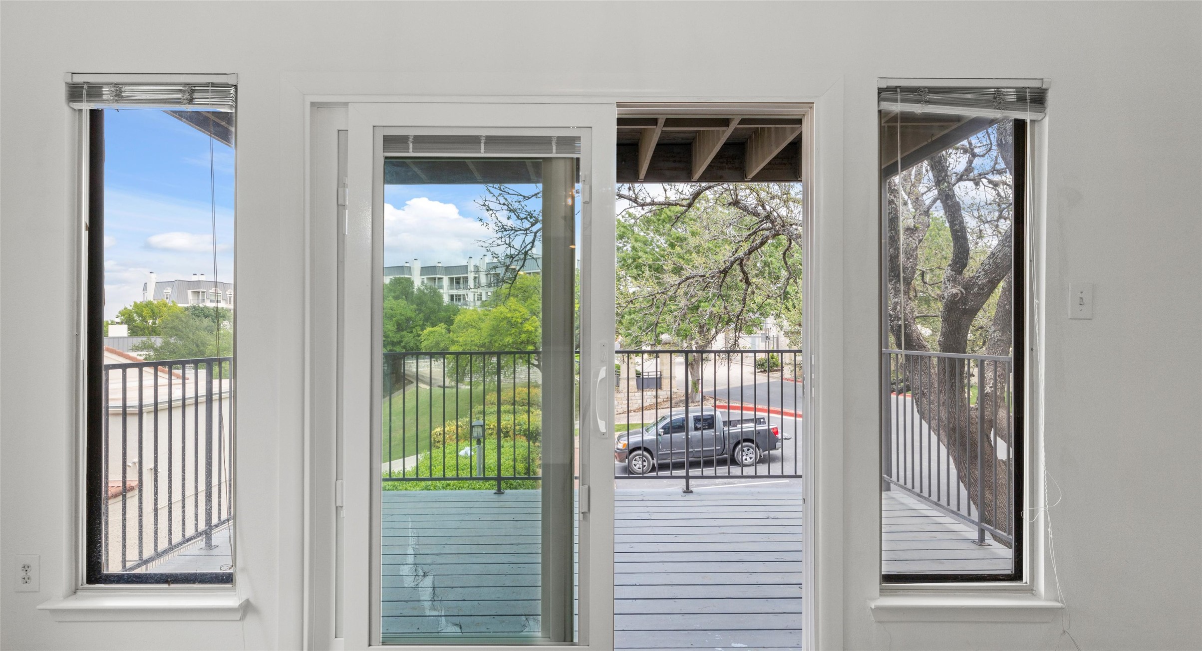 2918 Ranch Road 620 North, Unit C122 Austin, TX 78734 - Photo 12 of 36 This property features a balcony with a black metal railing and a view of trees and other properties