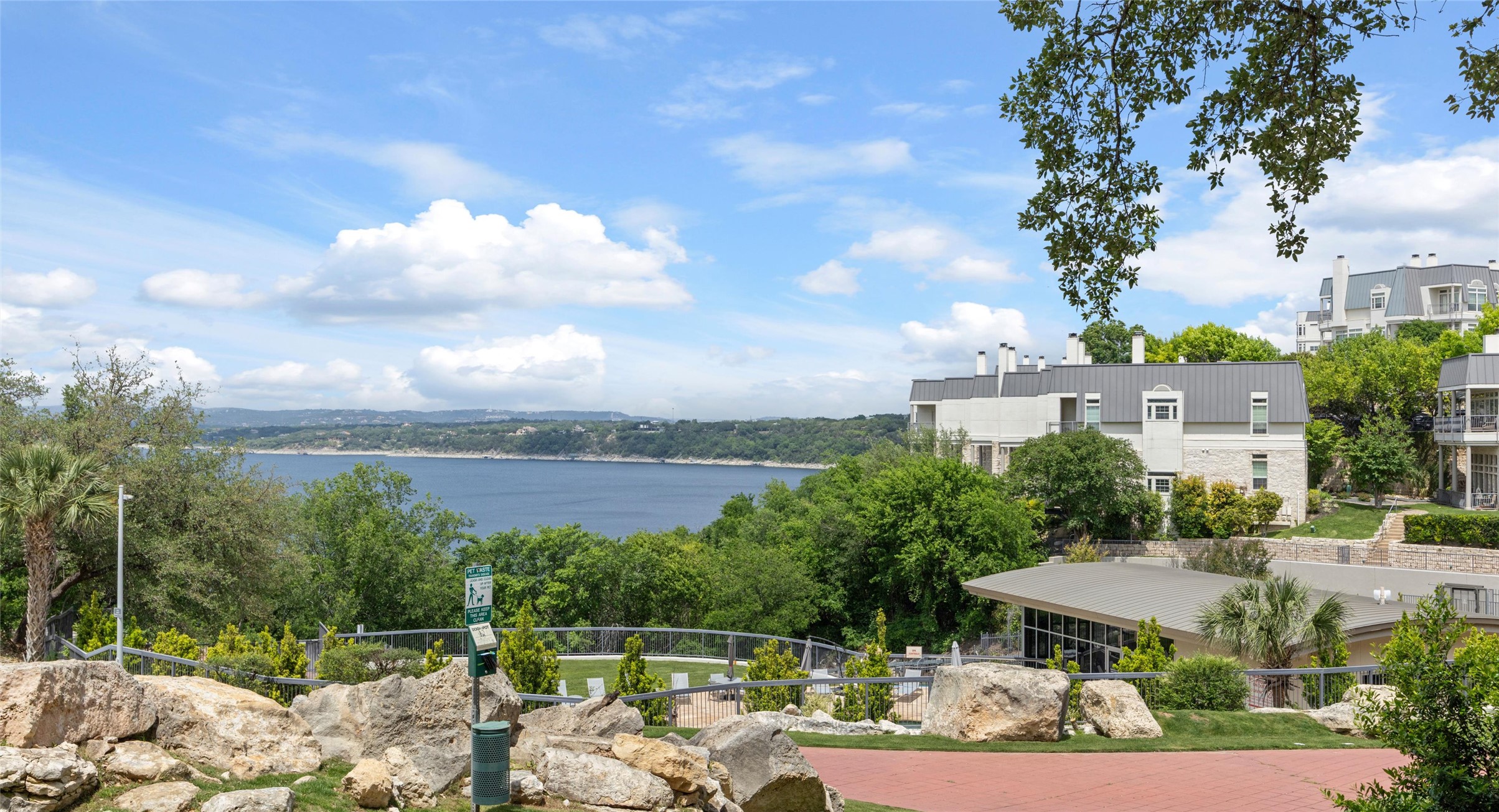 2918 Ranch Road 620 North, Unit C122 Austin, TX 78734 - Photo 25 of 36 The property offers scenic views of a large body of water and distant hills, with mature trees and landscaping in the foreground