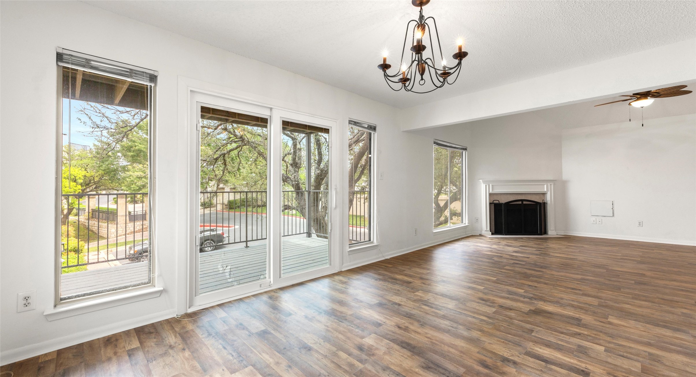 2918 Ranch Road 620 North, Unit C122 Austin, TX 78734 - Photo 3 of 36 Spacious living area featuring durable flooring, a decorative chandelier, and a ceiling fan
