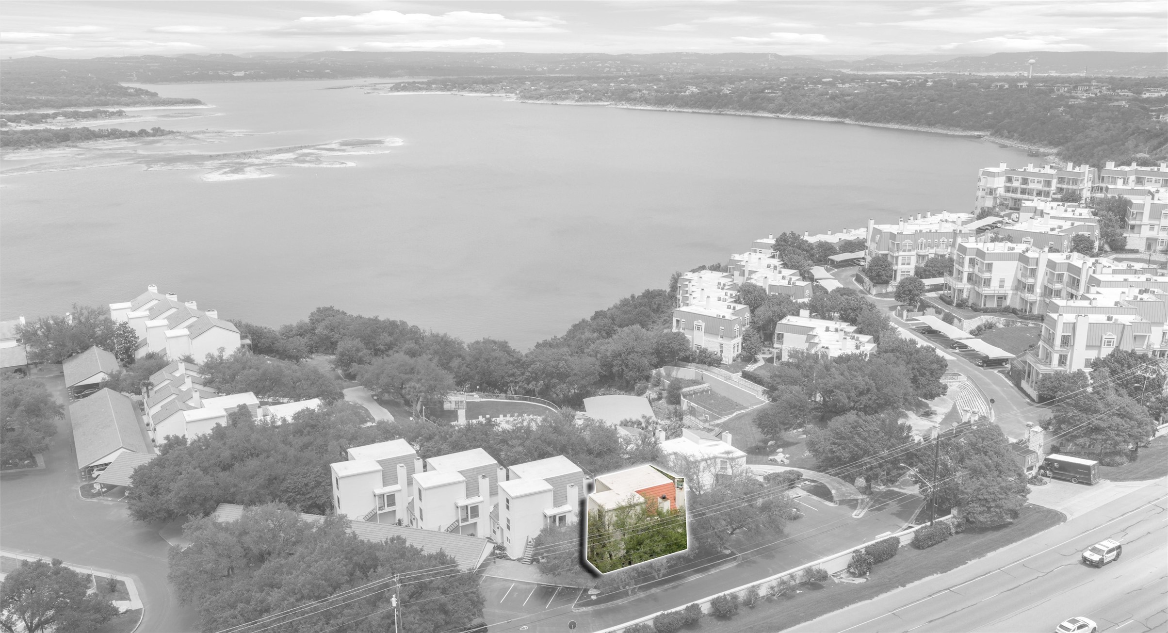 2918 Ranch Road 620 North, Unit C122 Austin, TX 78734 - Photo 33 of 36 Aerial view showcasing the property's location near a body of water, surrounded by trees and residential structures