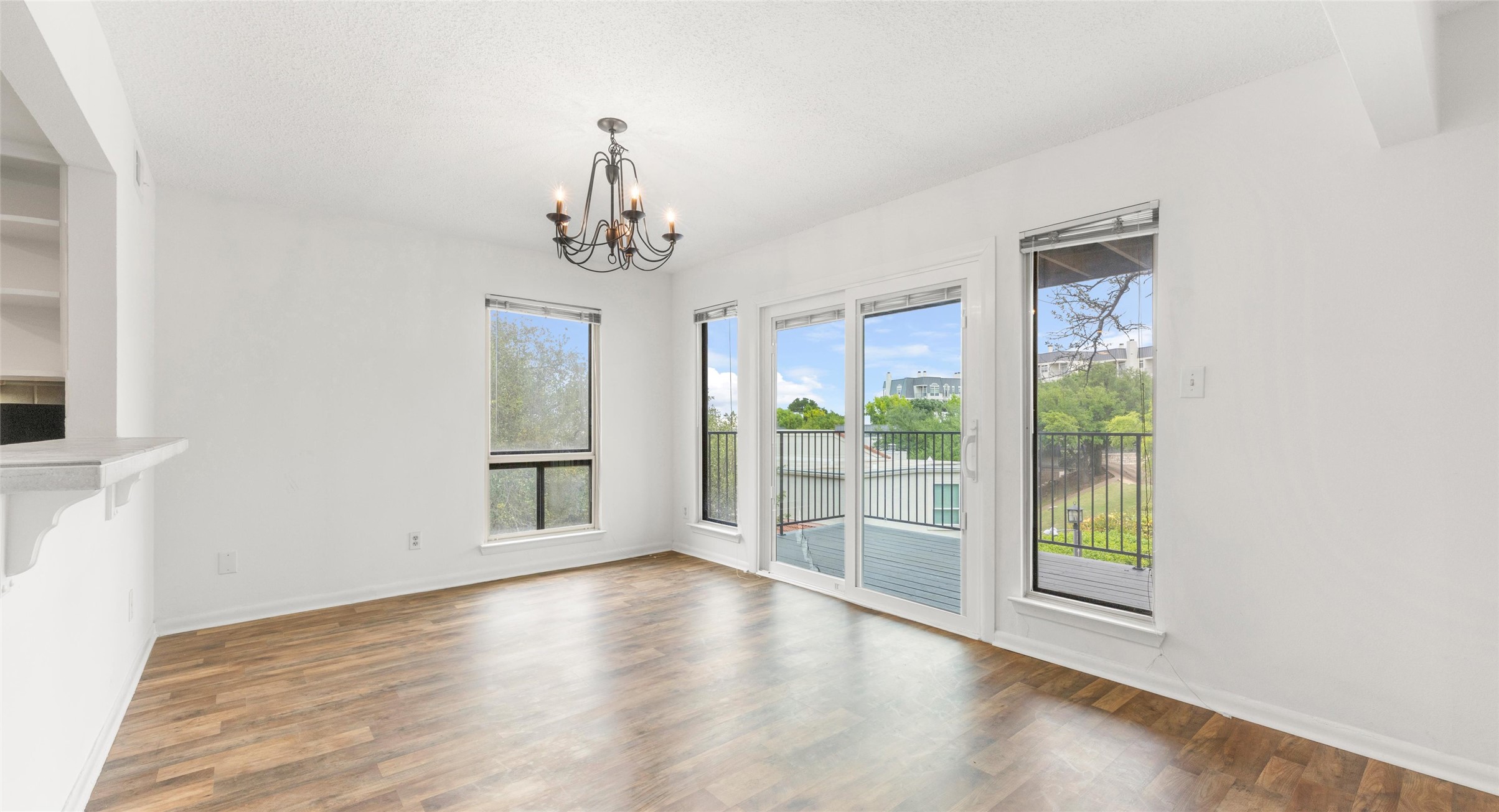 2918 Ranch Road 620 North, Unit C122 Austin, TX 78734 - Photo 8 of 36 This bright room features wood-look flooring, a chandelier, and a built-in shelf