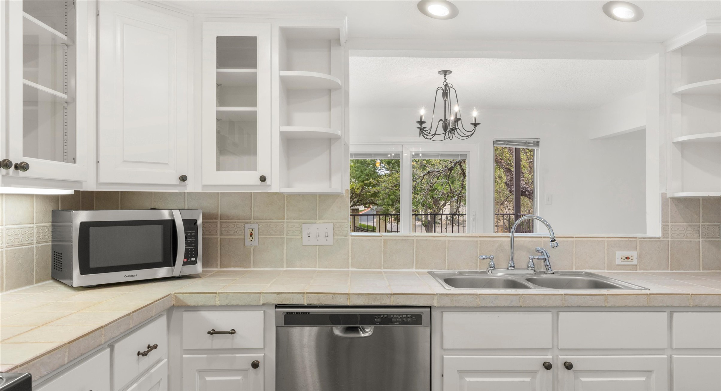 2918 Ranch Road 620 North, Unit C122 Austin, TX 78734 - Photo 9 of 36 The kitchen features white cabinetry, a double basin sink, and a stainless steel dishwasher