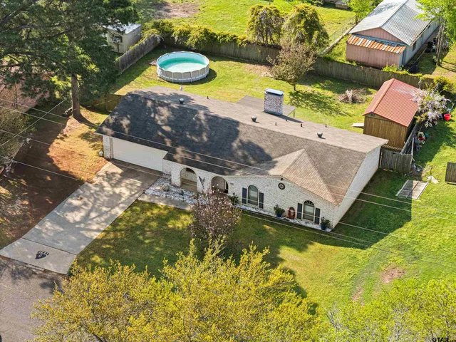 an aerial view of residential houses with yard