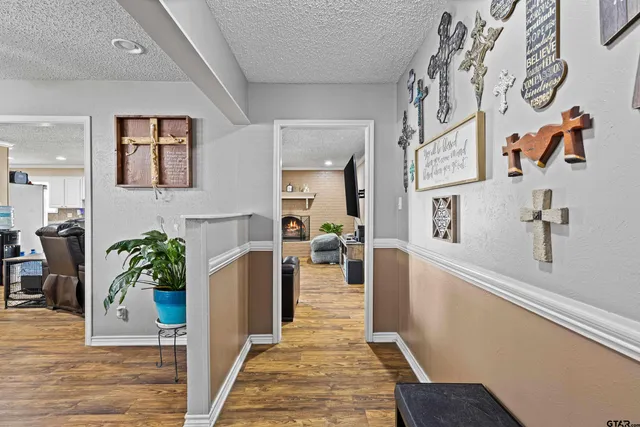 a hallway with a dining table and chairs