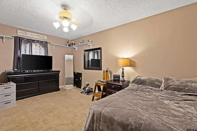 a bedroom with a bed and flat screen tv