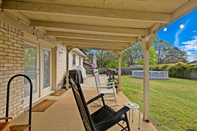 a view of a swimming pool with a patio