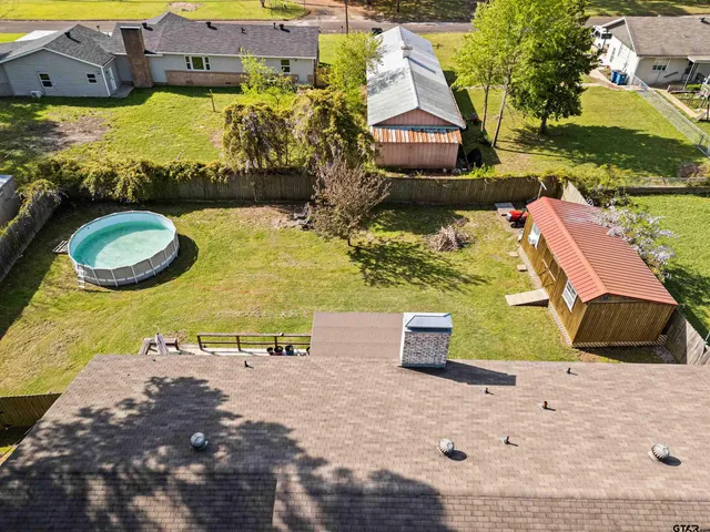 an aerial view of a house with outdoor space